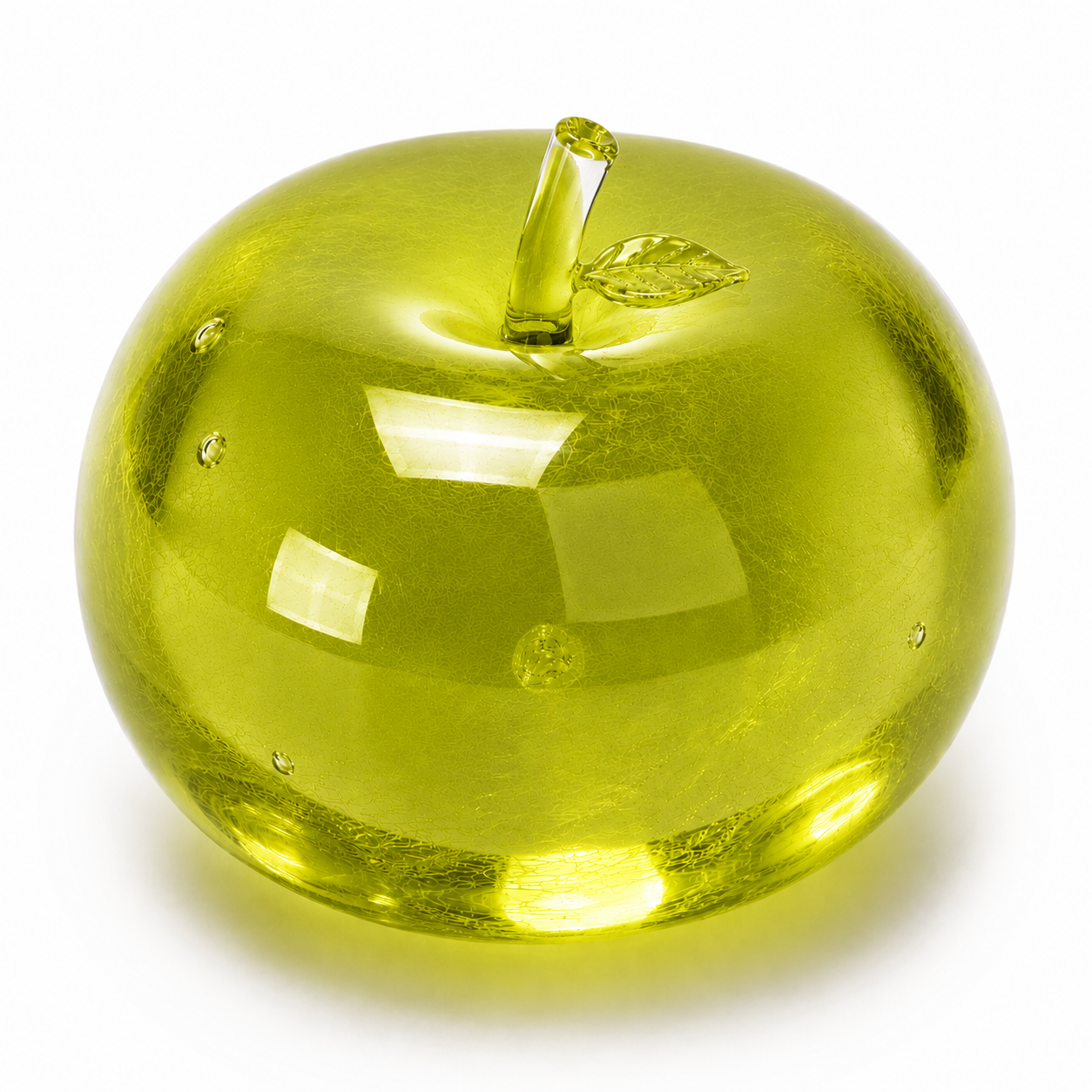 Shiny yellow apple with a leaf on a white background