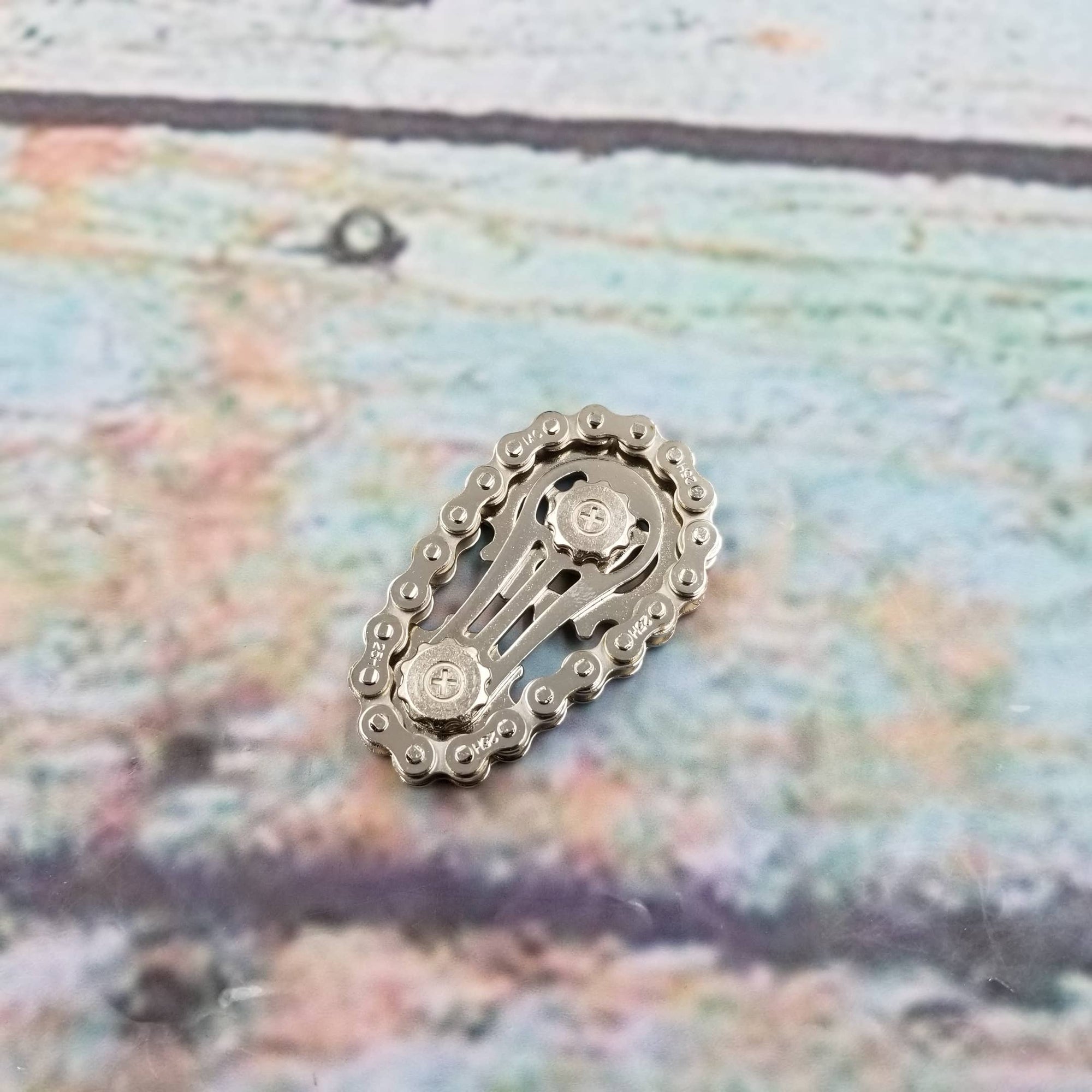 Metallic chain-like object on a textured surface