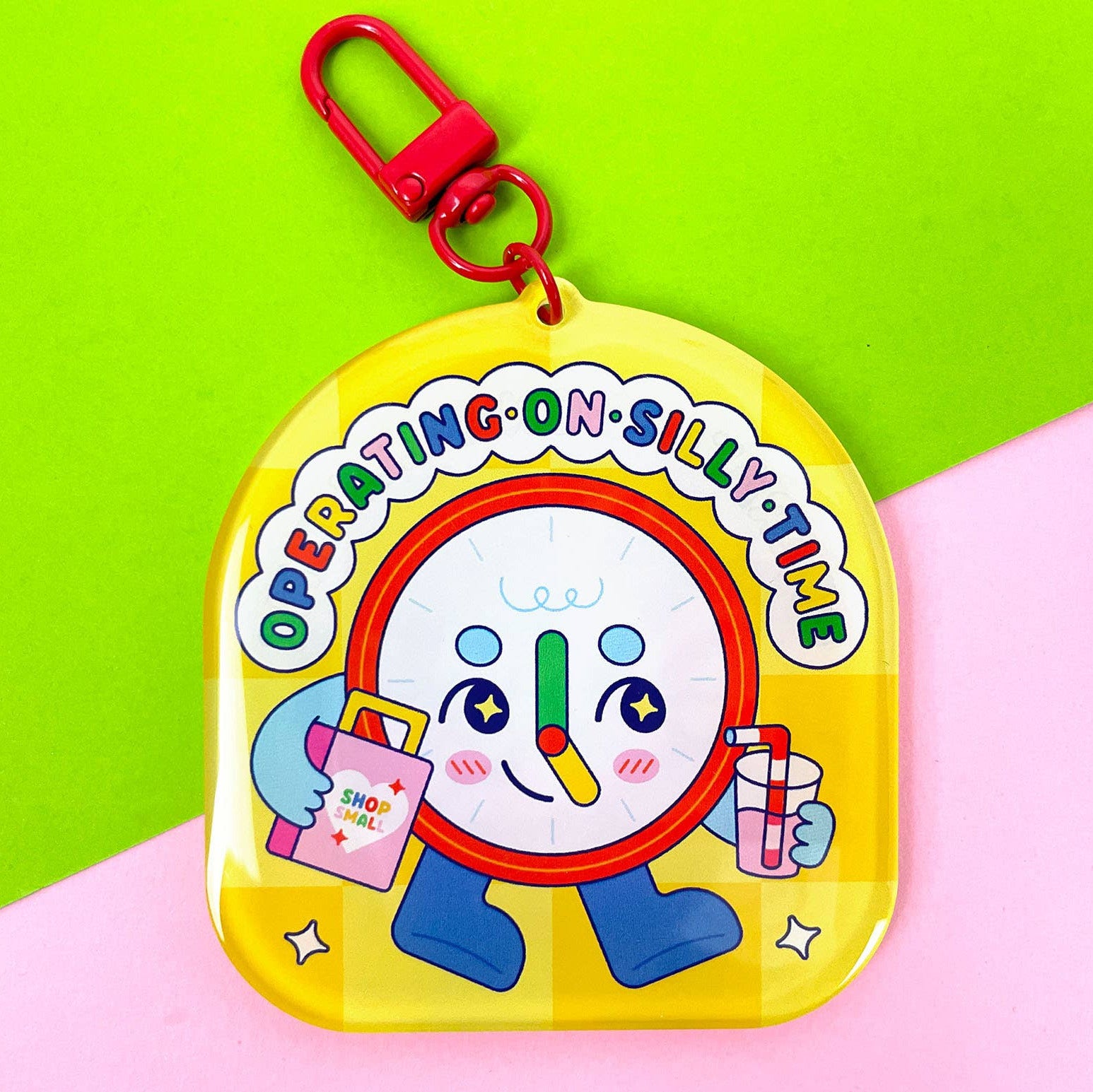 Colorful toy with a clock design on a green and pink background