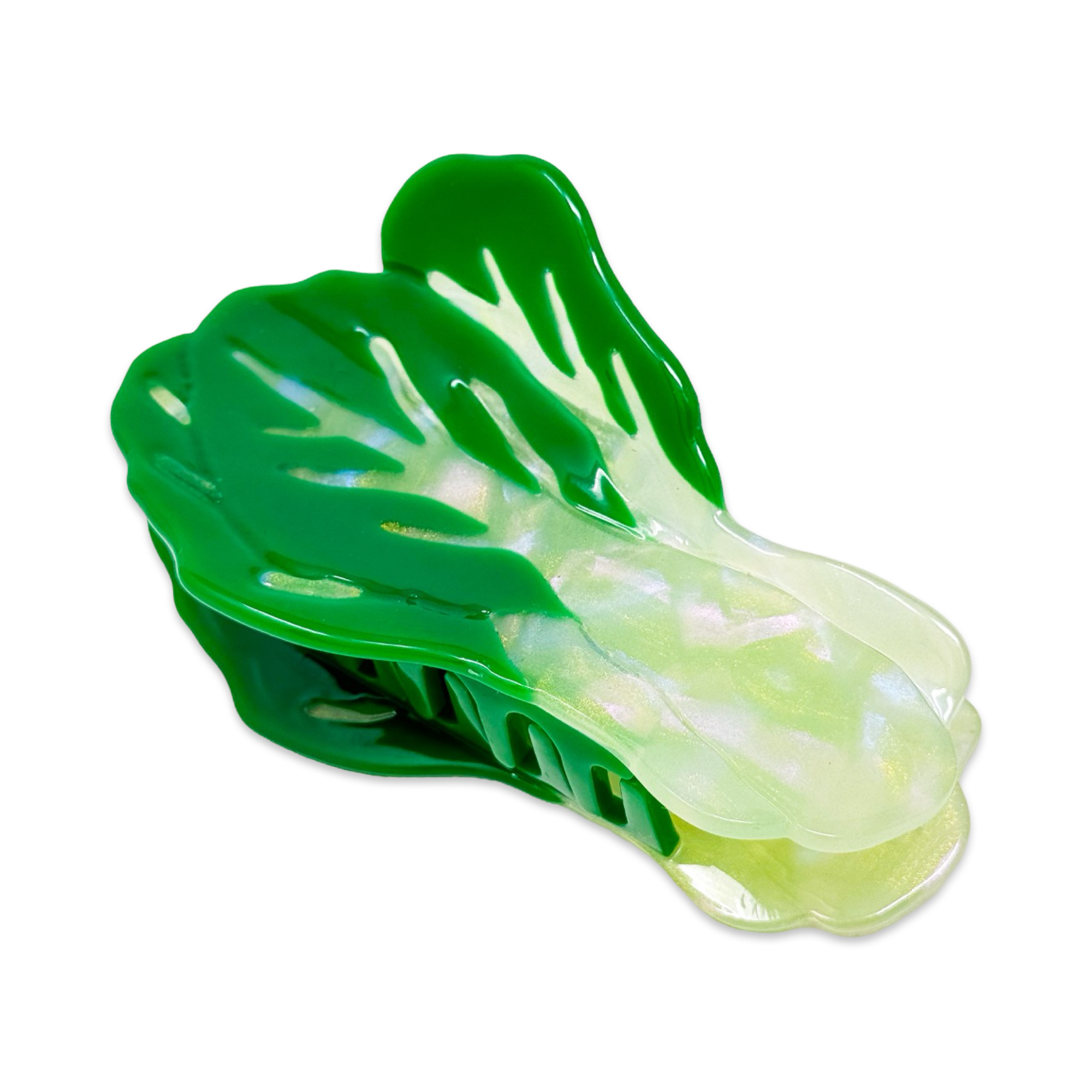 Green and white plastic vegetable-shaped tool on a white background