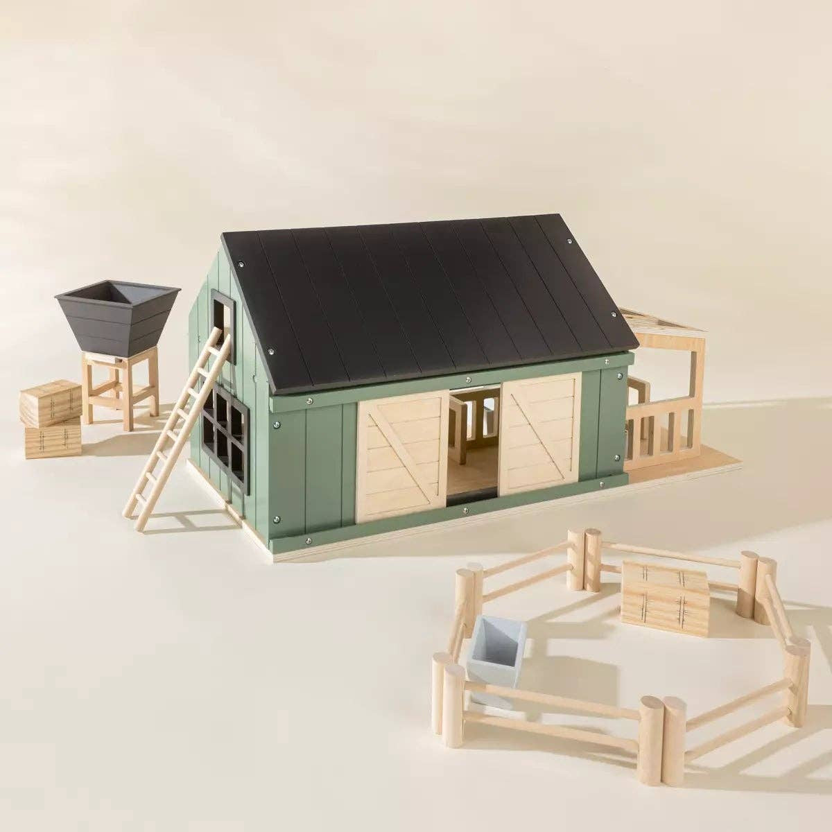 Model of a barn with a ladder and fence on a light background