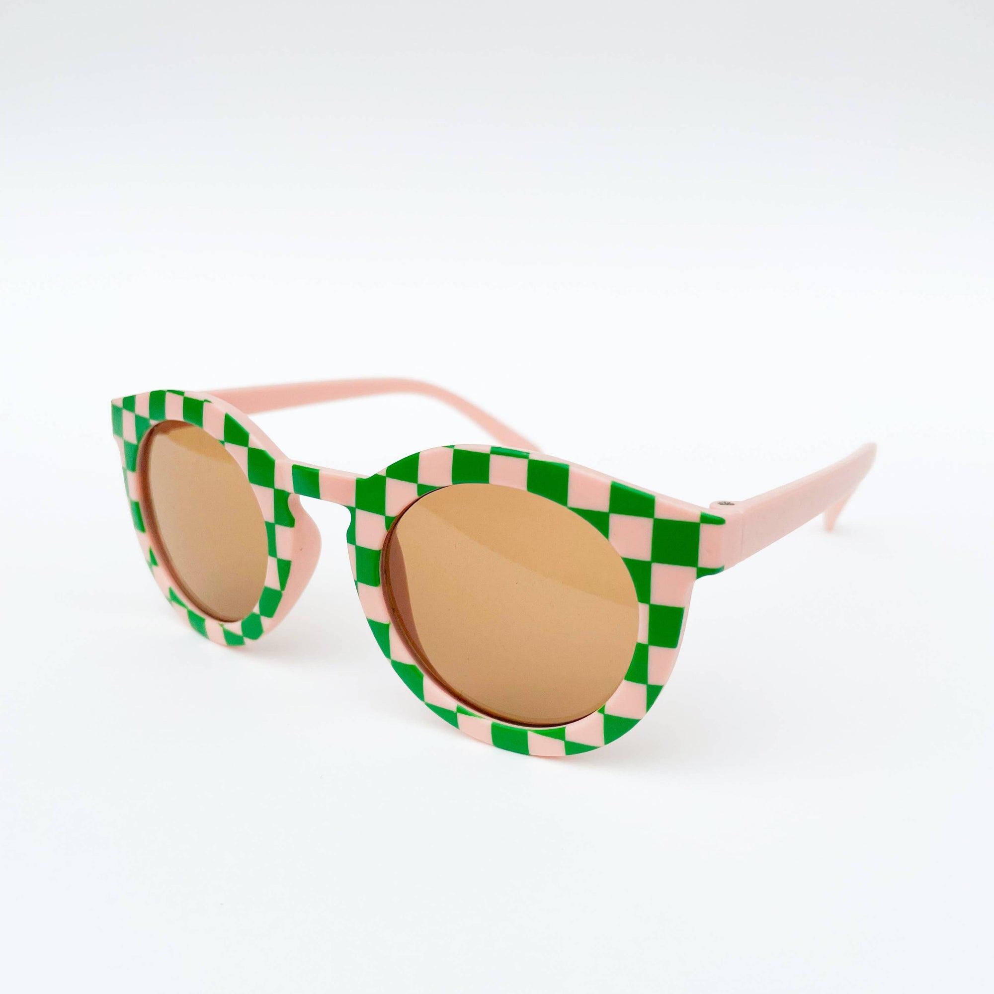Sunglasses with green and pink checkered frame on a white background