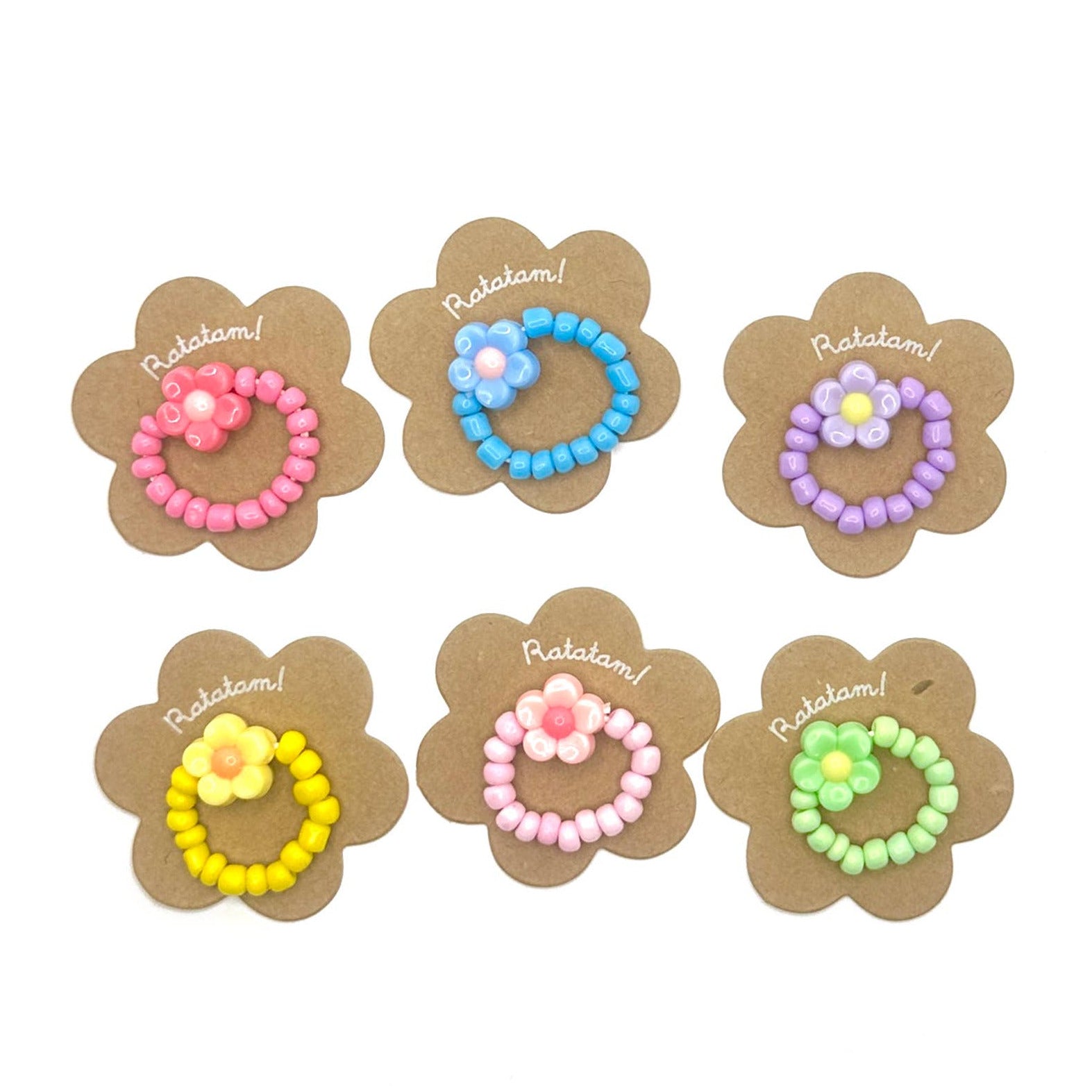 Set of colorful beaded hair ties on flower-shaped cards with 'Rakelam!' branding.