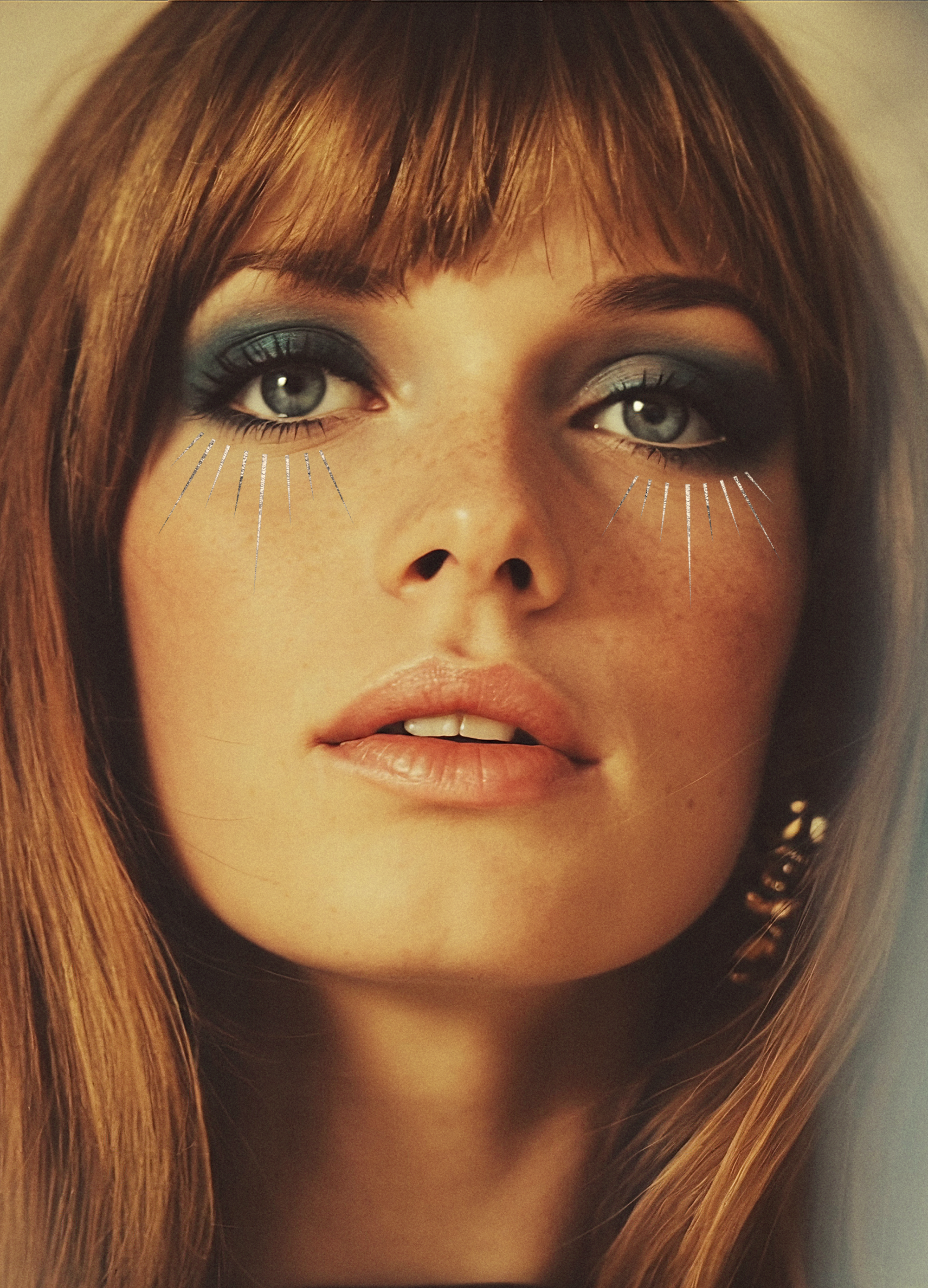 Close-up of a person with long hair and dramatic makeup