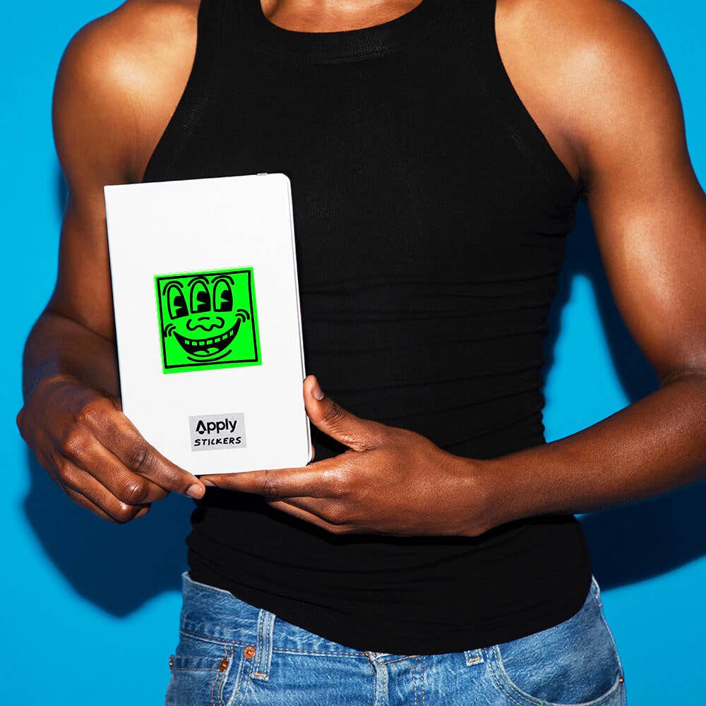 Person holding a white card with a green graphic design against a blue background