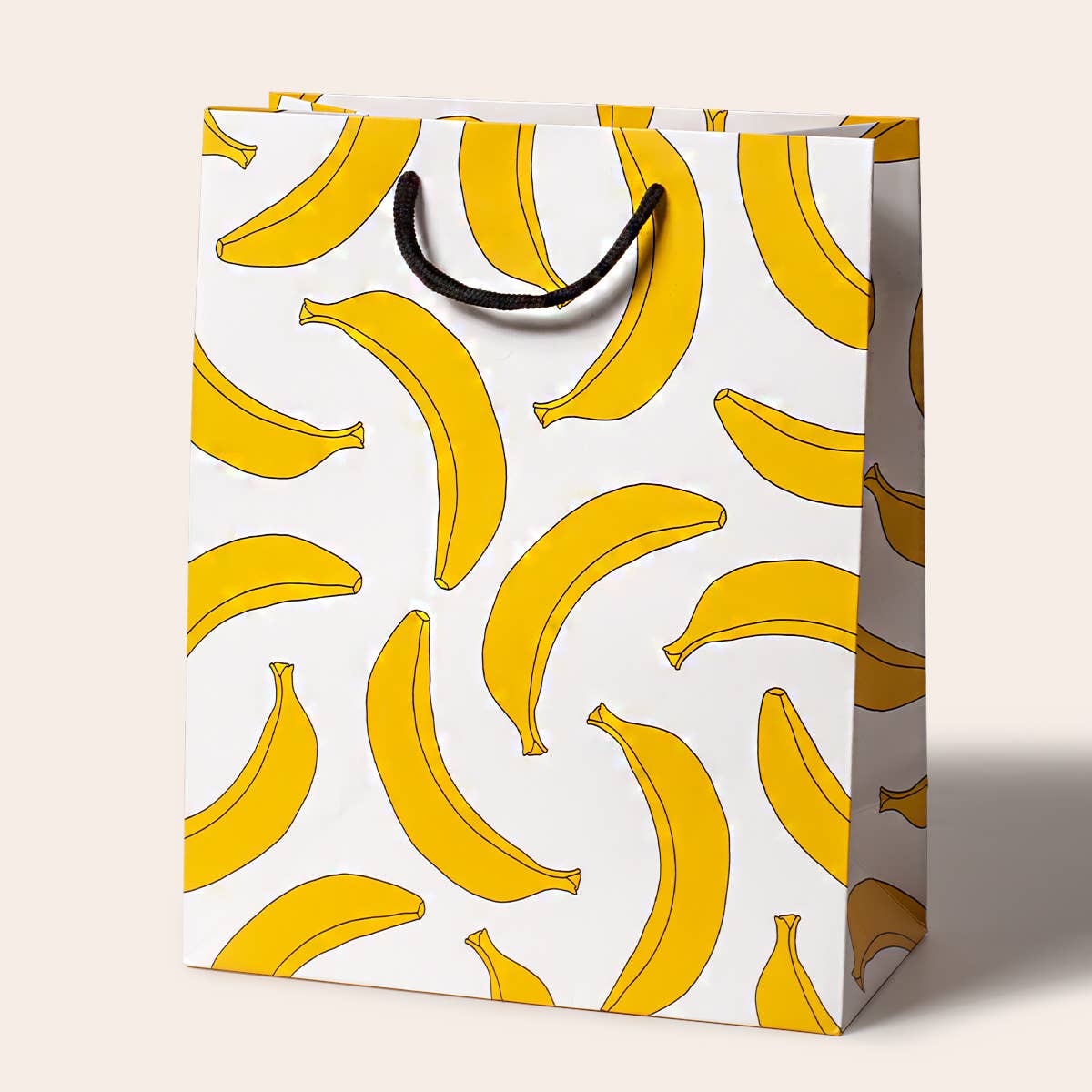 Gift bag with yellow banana pattern on a white background