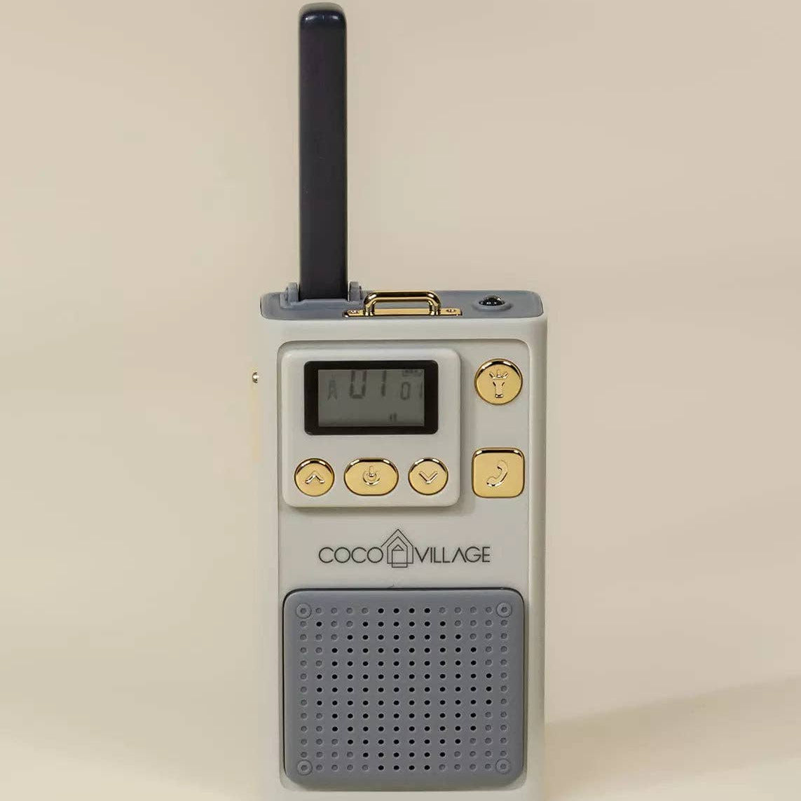 Small portable radio with digital display and buttons on a beige background, branded 'Coco Village'.