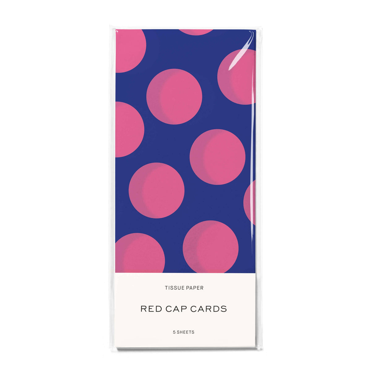 A package of Red Cap Cards tissue paper featuring a navy blue background with large pink polka dots and a white label at the bottom that reads 'TISSUE PAPER' and 'RED CAP CARDS' with '5 SHEETS' below.