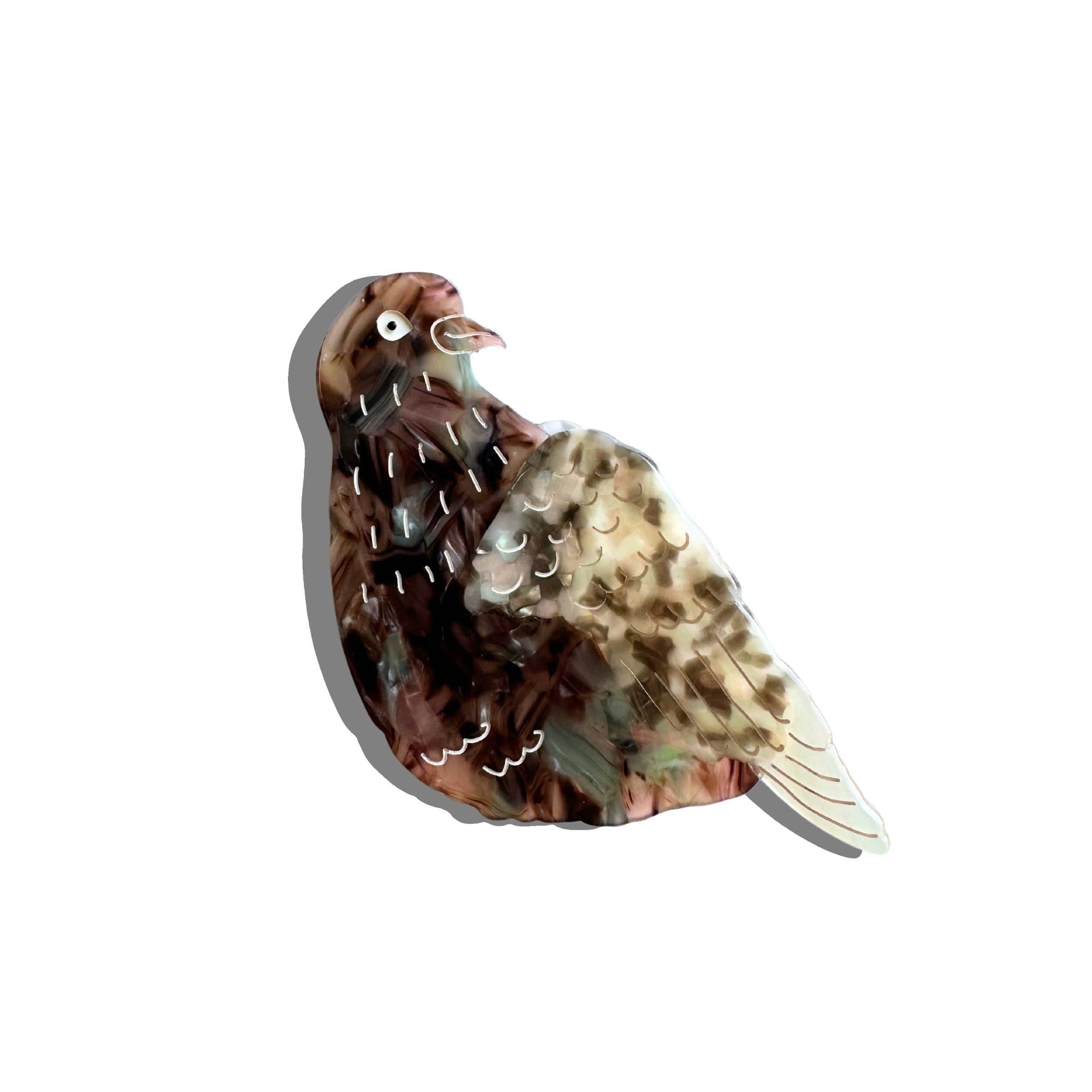 Decorative bird-shaped object with a feather pattern on a white background