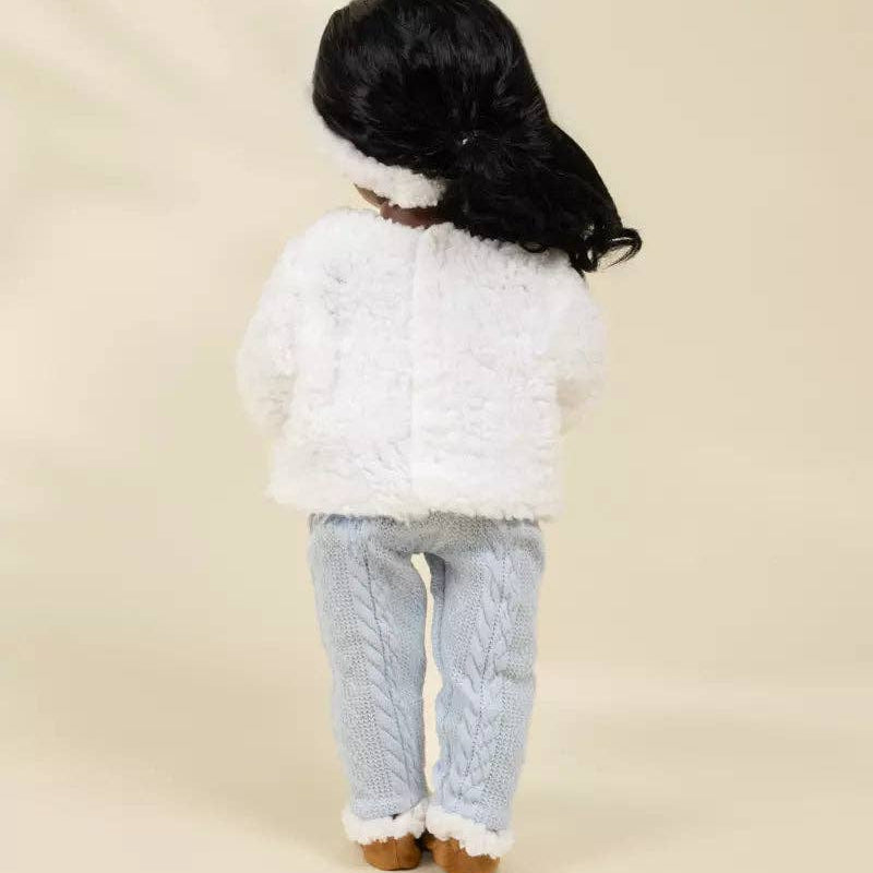 doll wearing a white fluffy sweater and light blue pants on a beige background