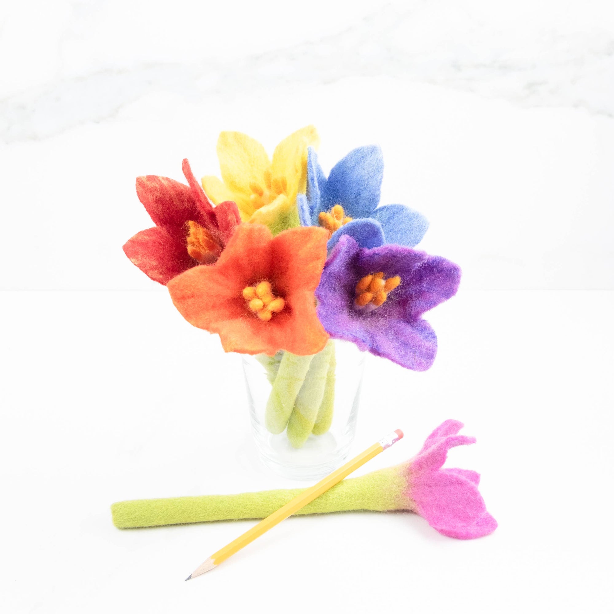 Colorful felt flowers on a white background