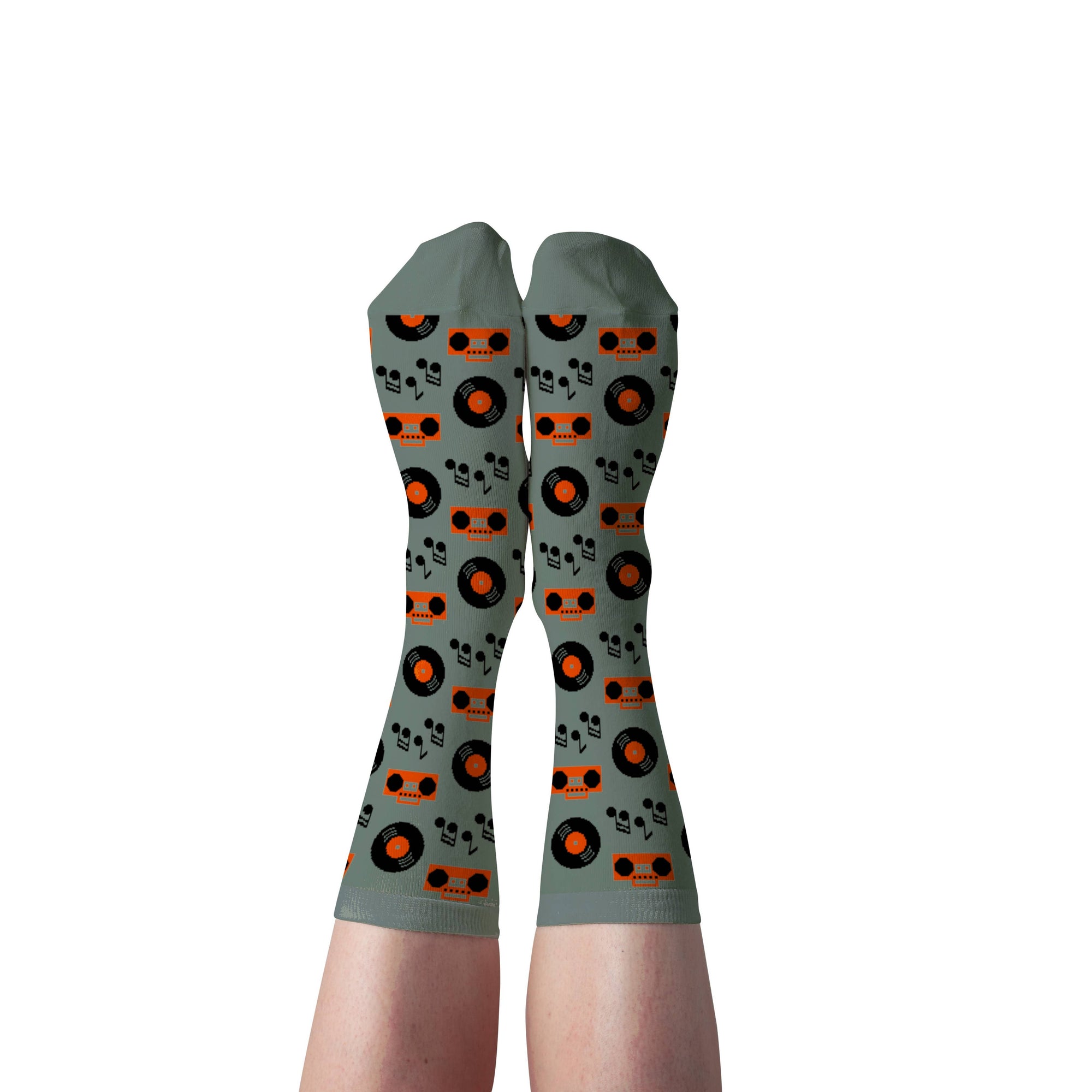 Gray socks with orange and black pattern worn by a person on a white background