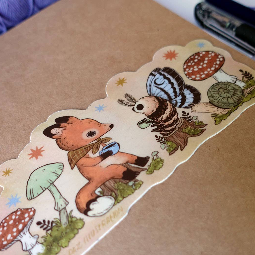 Sticker with a fox and hedgehog design on a brown surface