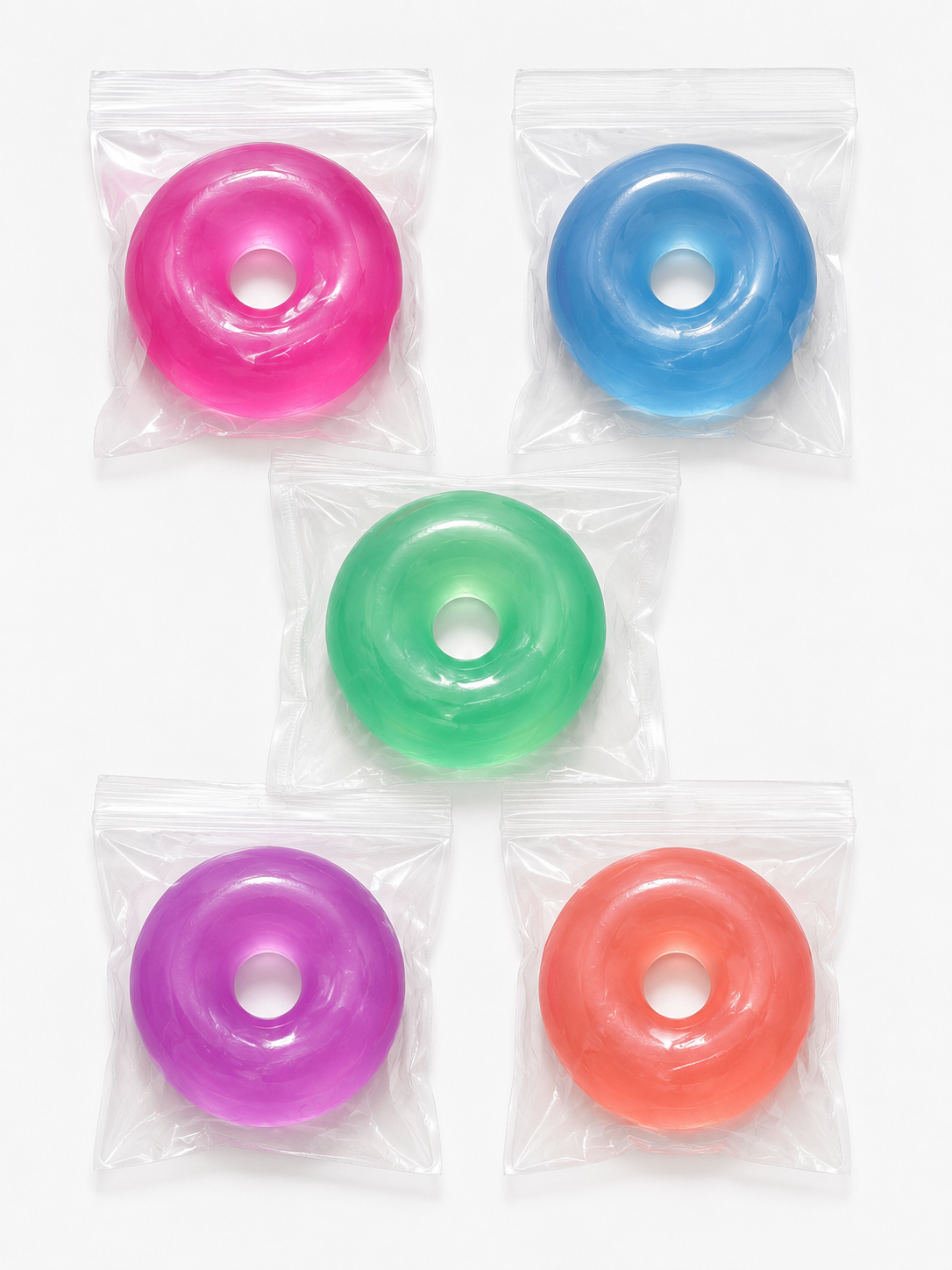 Five colorful donut-shaped gummies in clear packaging on a white background