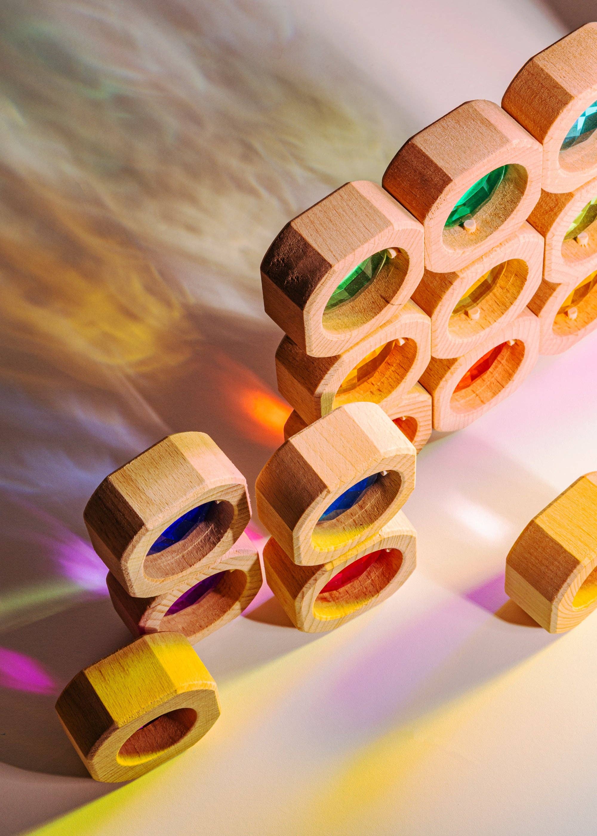 Wooden blocks with colorful interior lights on a gradient background
