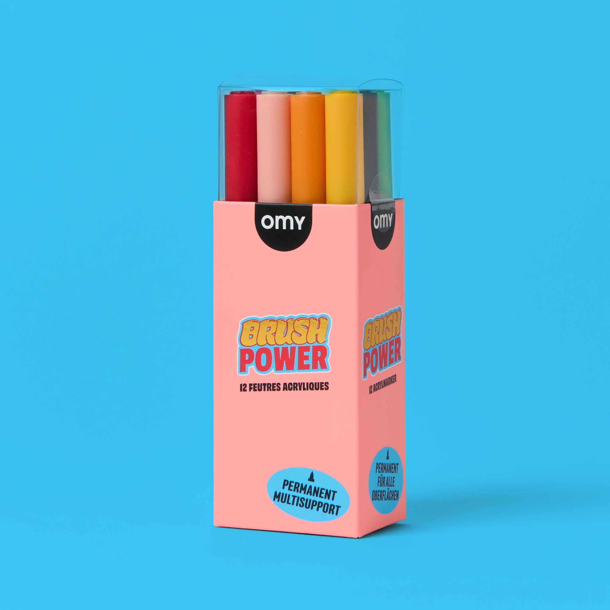 Box of colorful acrylic brushes with 'OMY' branding on a blue background