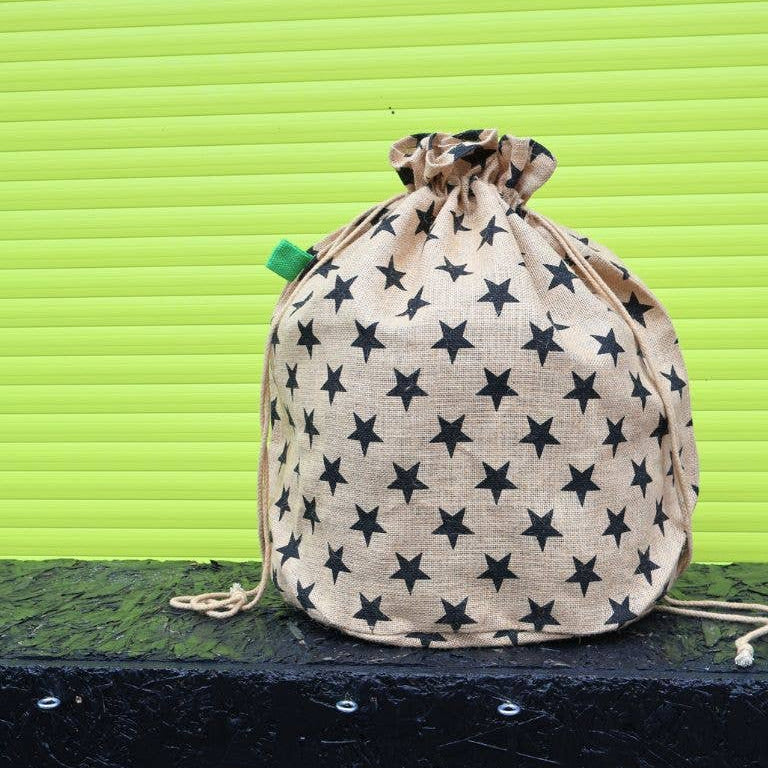 Drawstring bag with star pattern on a green background