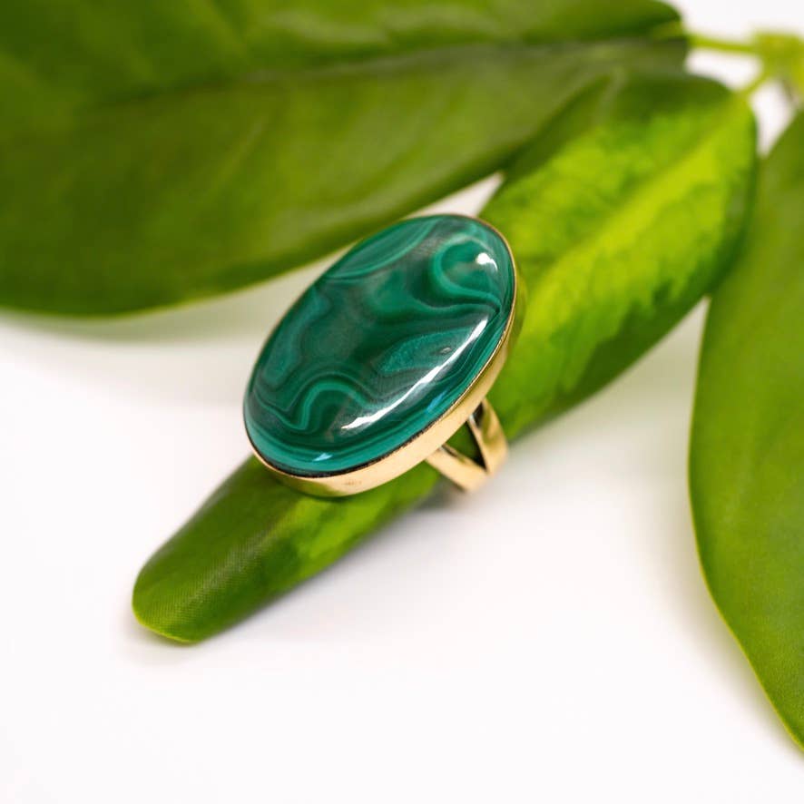 Green ring with gold band on a green leaf