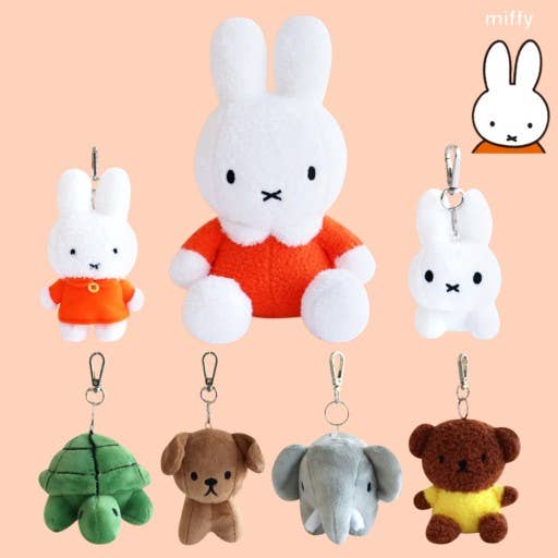 Collection of plush keychains including a rabbit, turtle, dog, elephant, and bear on a peach background.