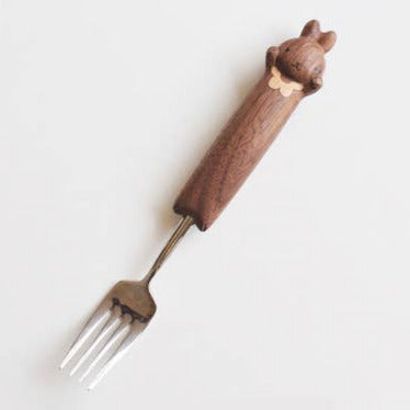 Fork with a wooden handle shaped like a bear on a white background