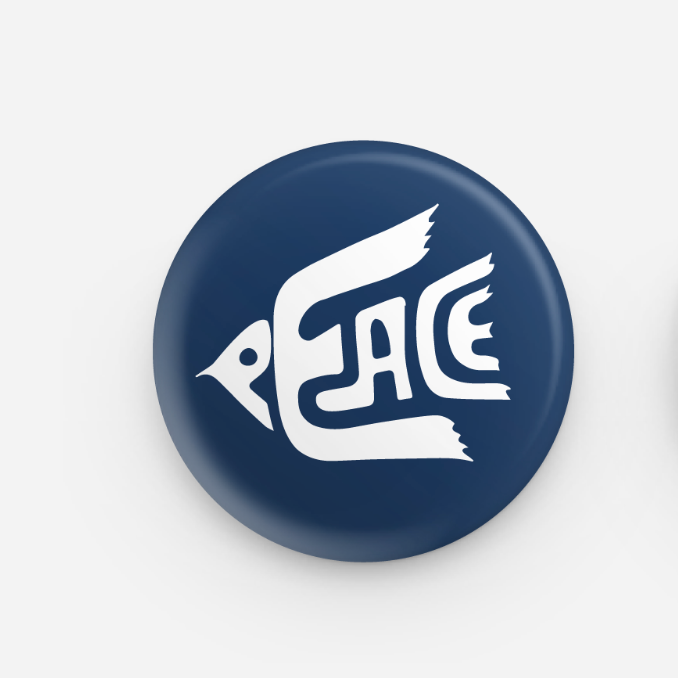Navy blue button with white 'PEACE' design on a light gray background