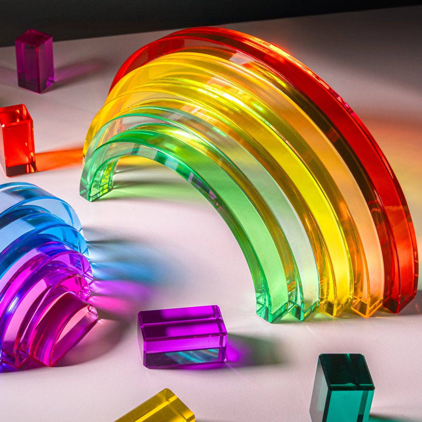 Colorful transparent geometric shapes on a white surface