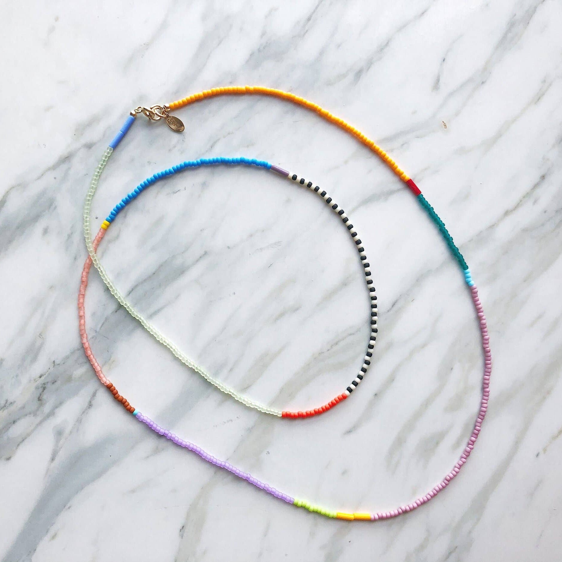 Colorful beaded necklace on a marble surface