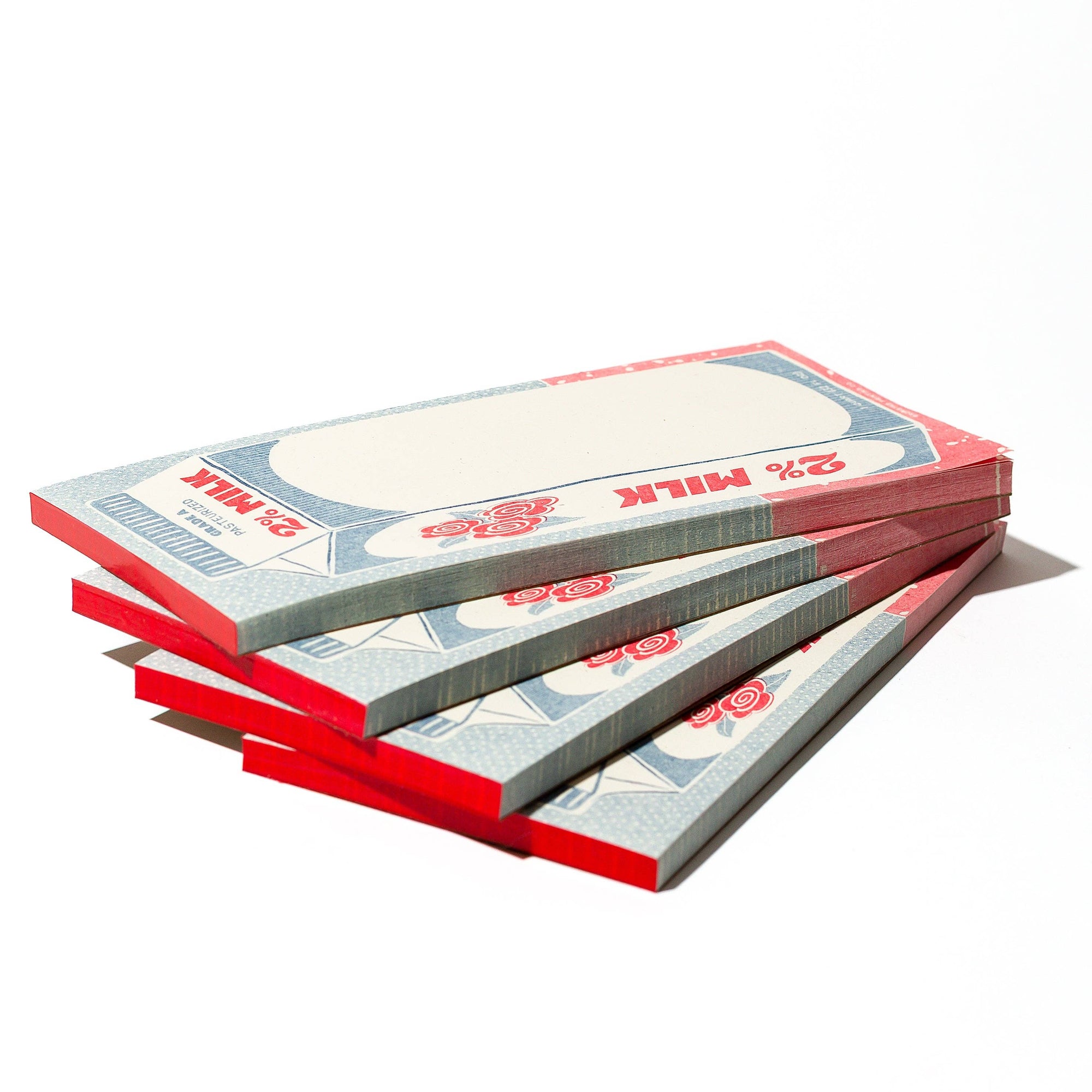 Stack of milk carton notepads on a white background