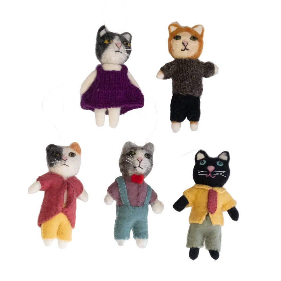 Five cat-shaped toys in various outfits on a white background
