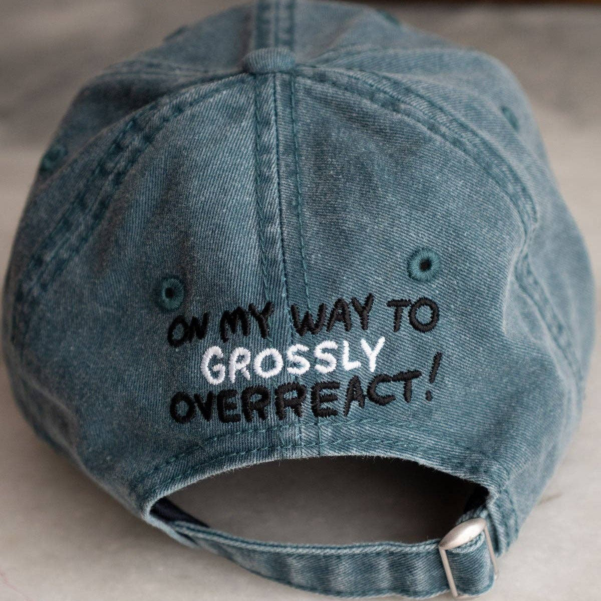 Blue denim cap with text on a light background