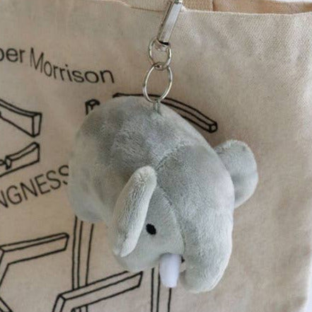 Gray plush elephant keychain hanging from a beige tote bag with 'Jasper Morrison' branding.