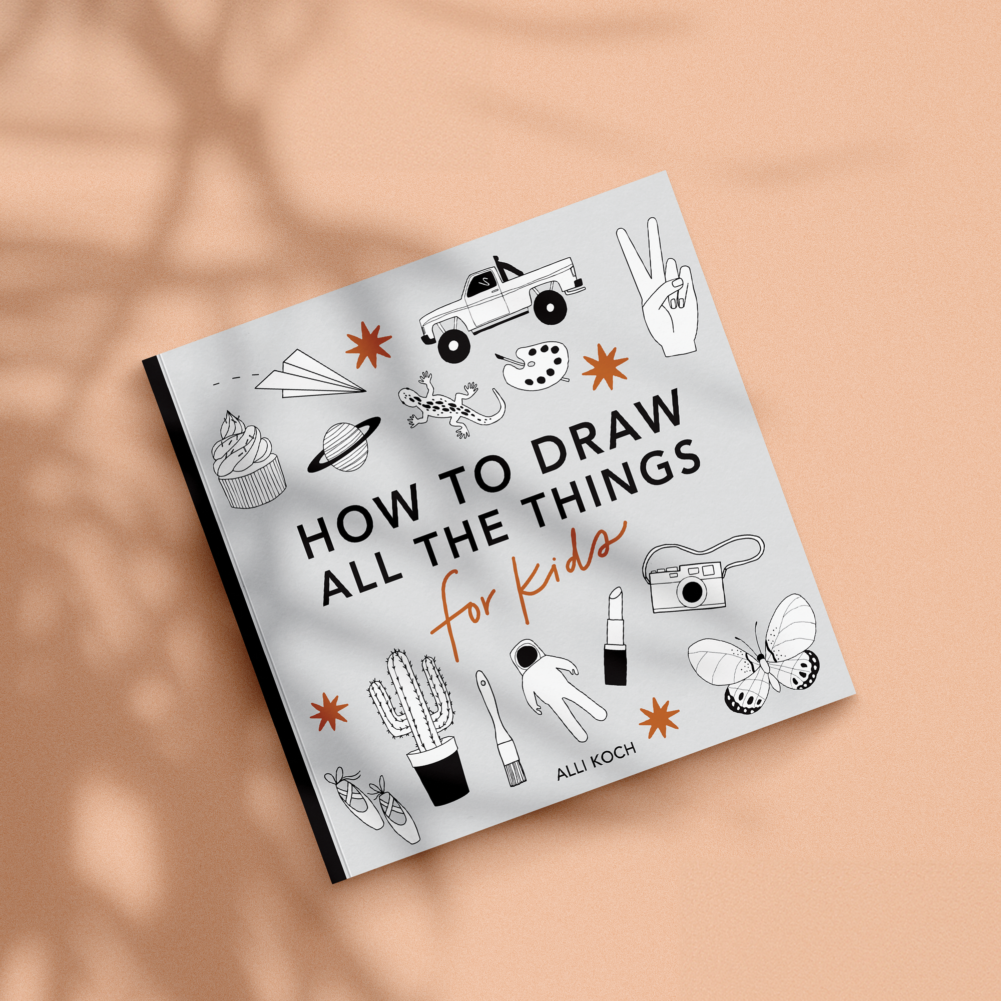 Book titled 'How to Draw All the Things for Kids' on a beige background