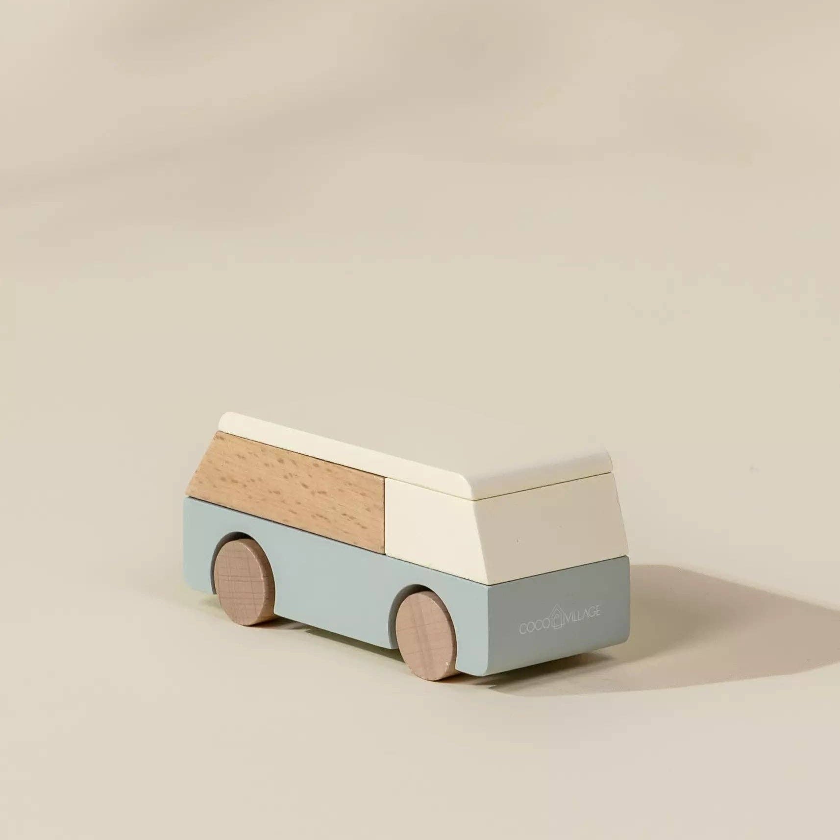 Wooden toy van on a beige background