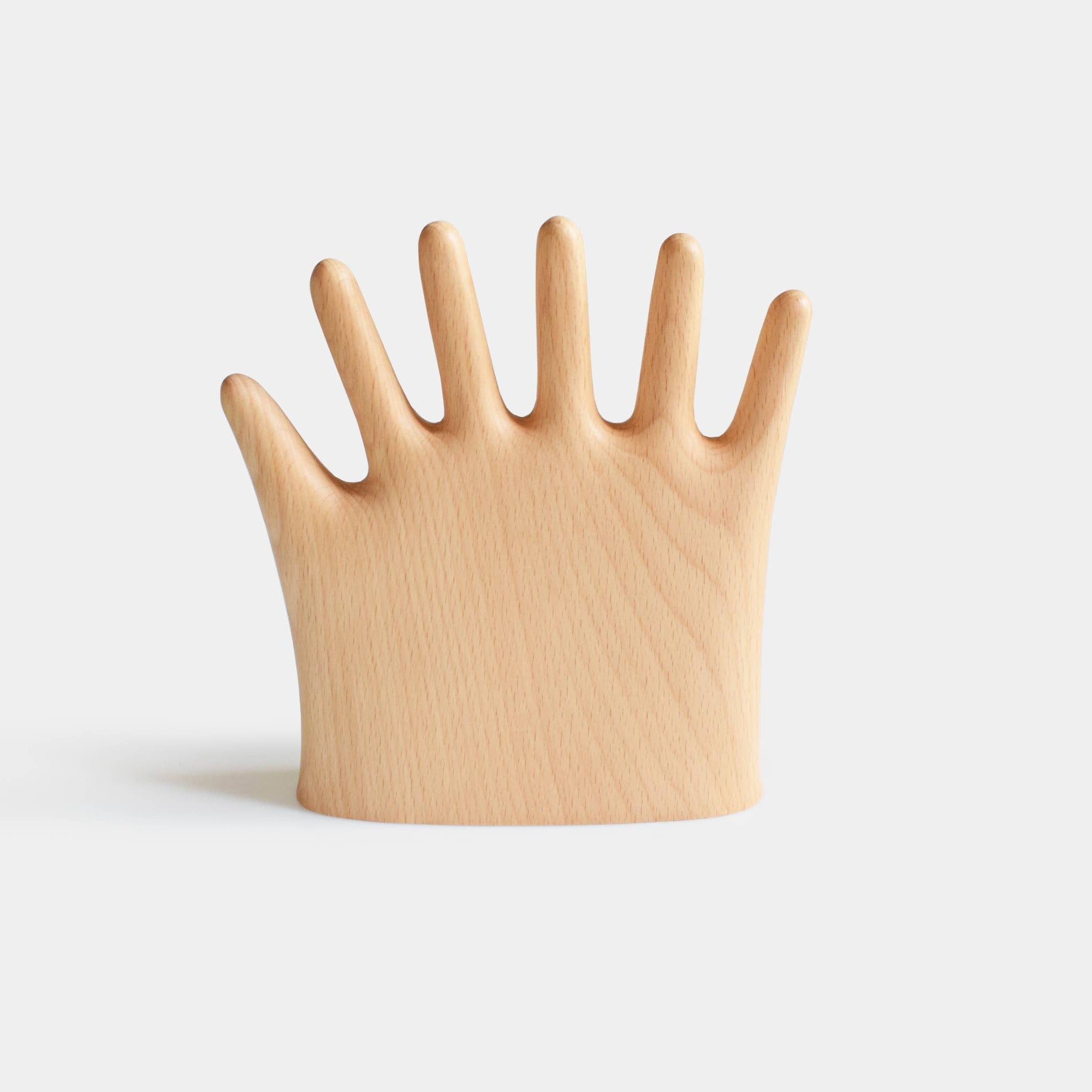 Wooden hand-shaped object on a light gray background