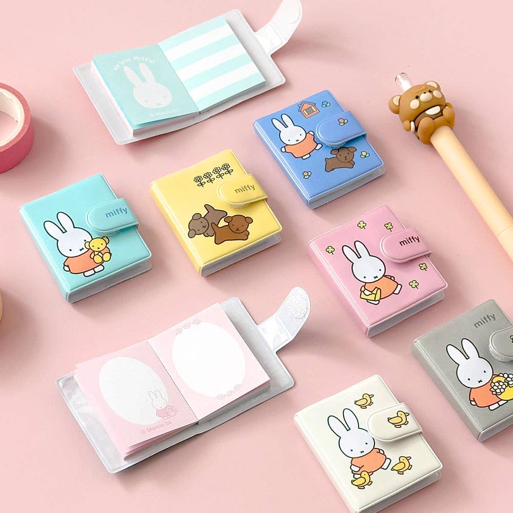 Set of small notebooks with cartoon character design on a pink background