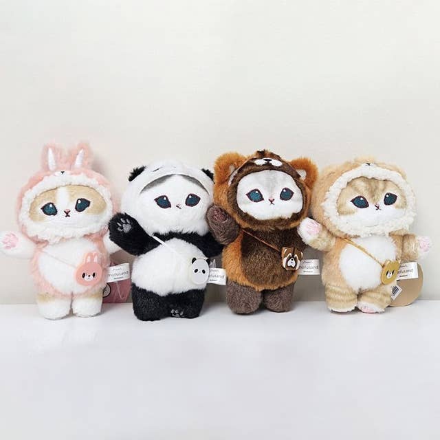 Four plush toys in different animal costumes on a white background