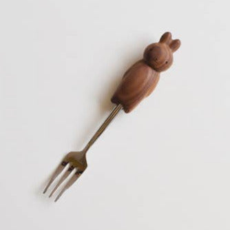 Wooden-handled fork with owl design on a white background