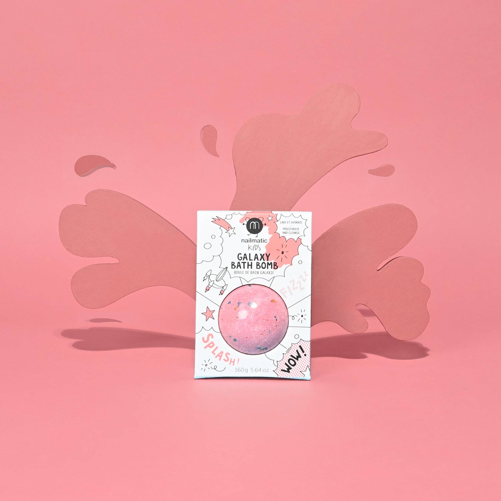 Galaxy bath bomb packaging on a pink background