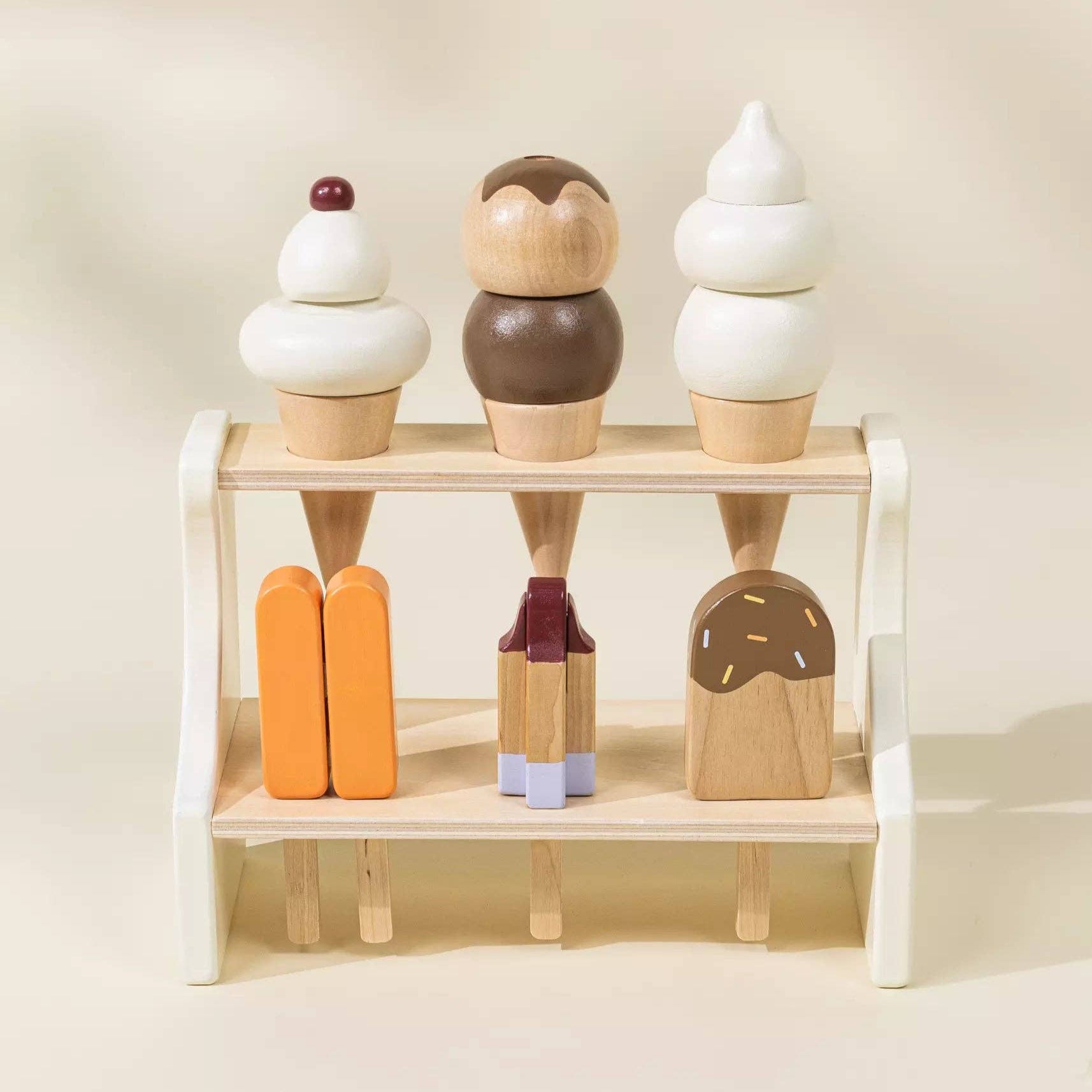Wooden ice cream toy set on a white shelf against a beige background