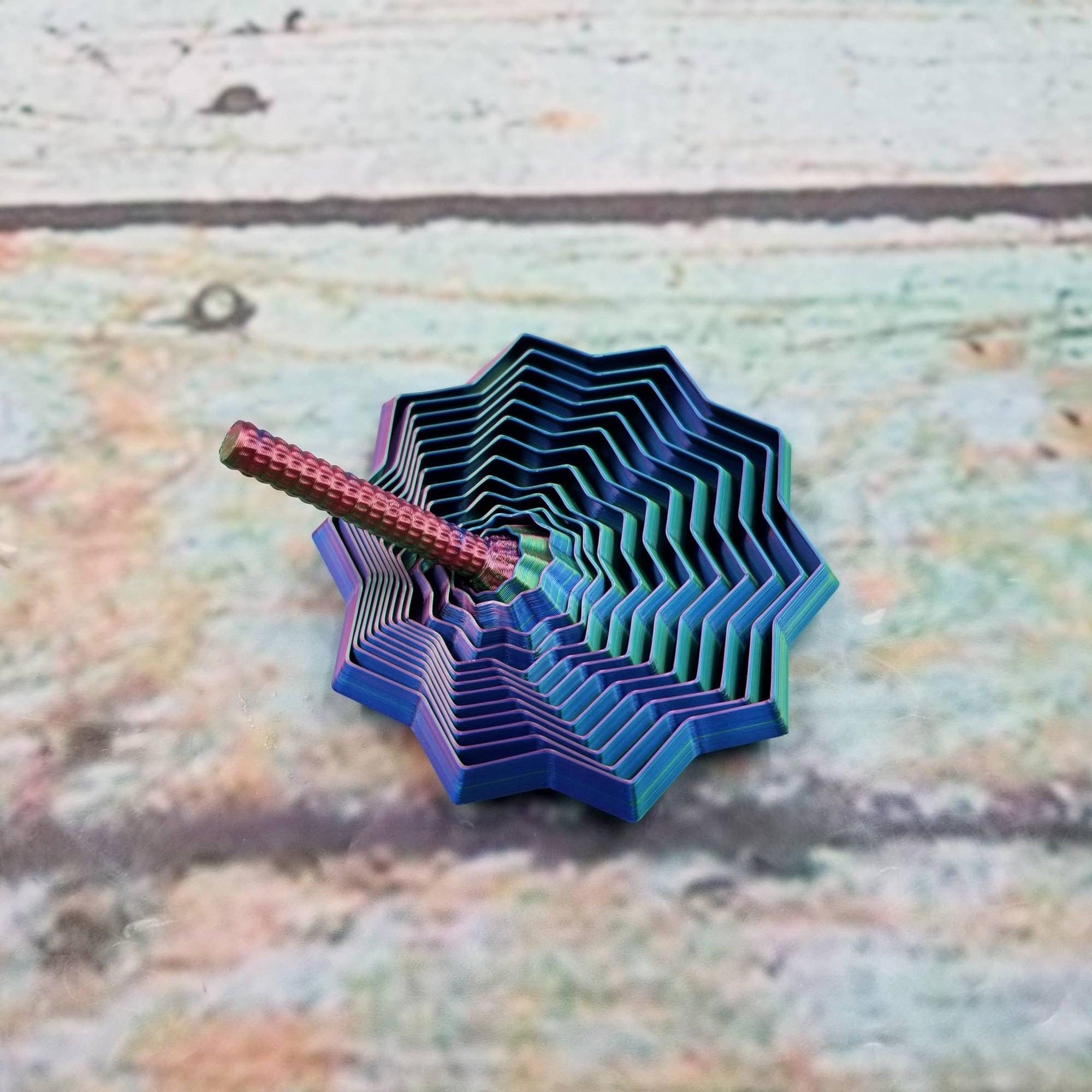 Blue and pink geometric object on a textured surface