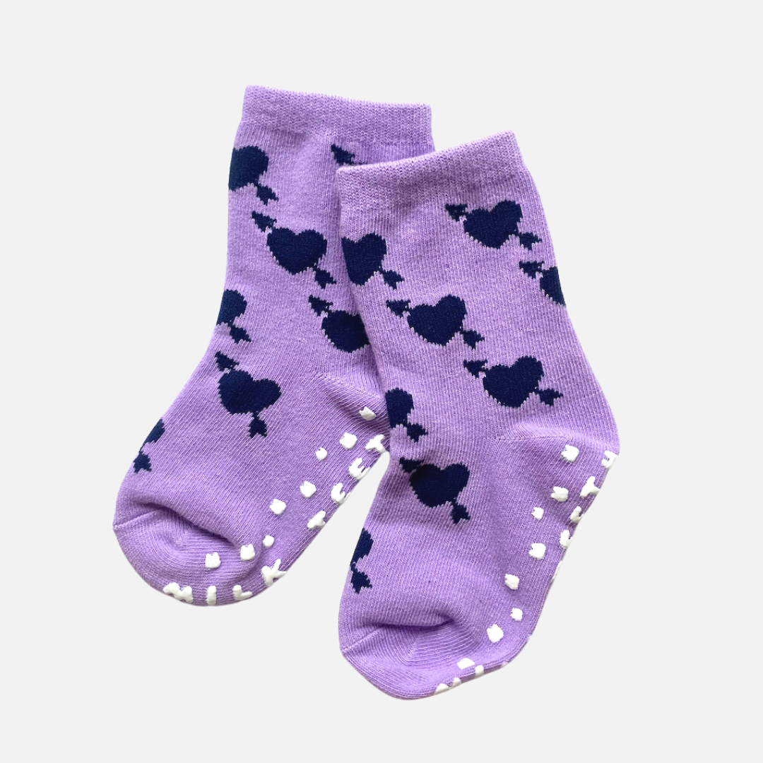 Purple socks with black heart patterns on a light gray background