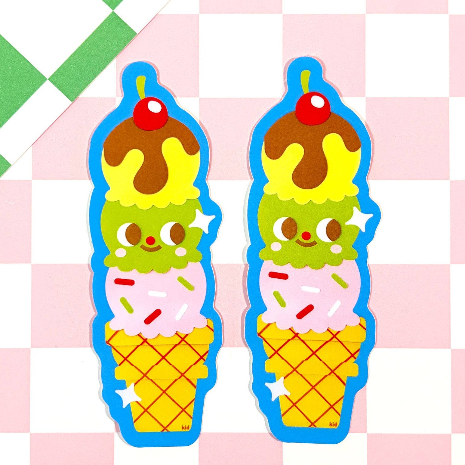 Pair of ice cream cone-shaped cookie cutters on a checkered background