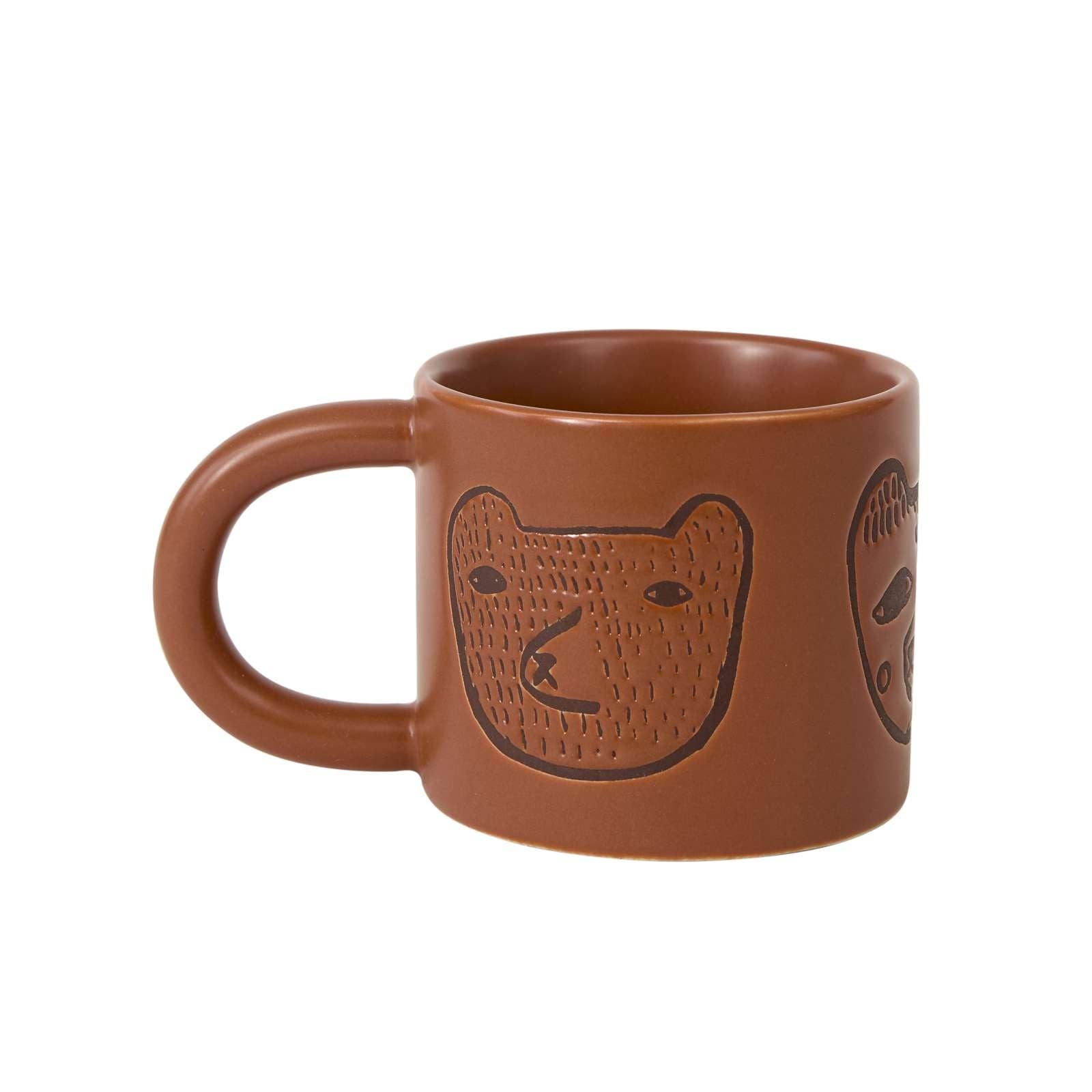 Brown ceramic mug with bear design on a white background