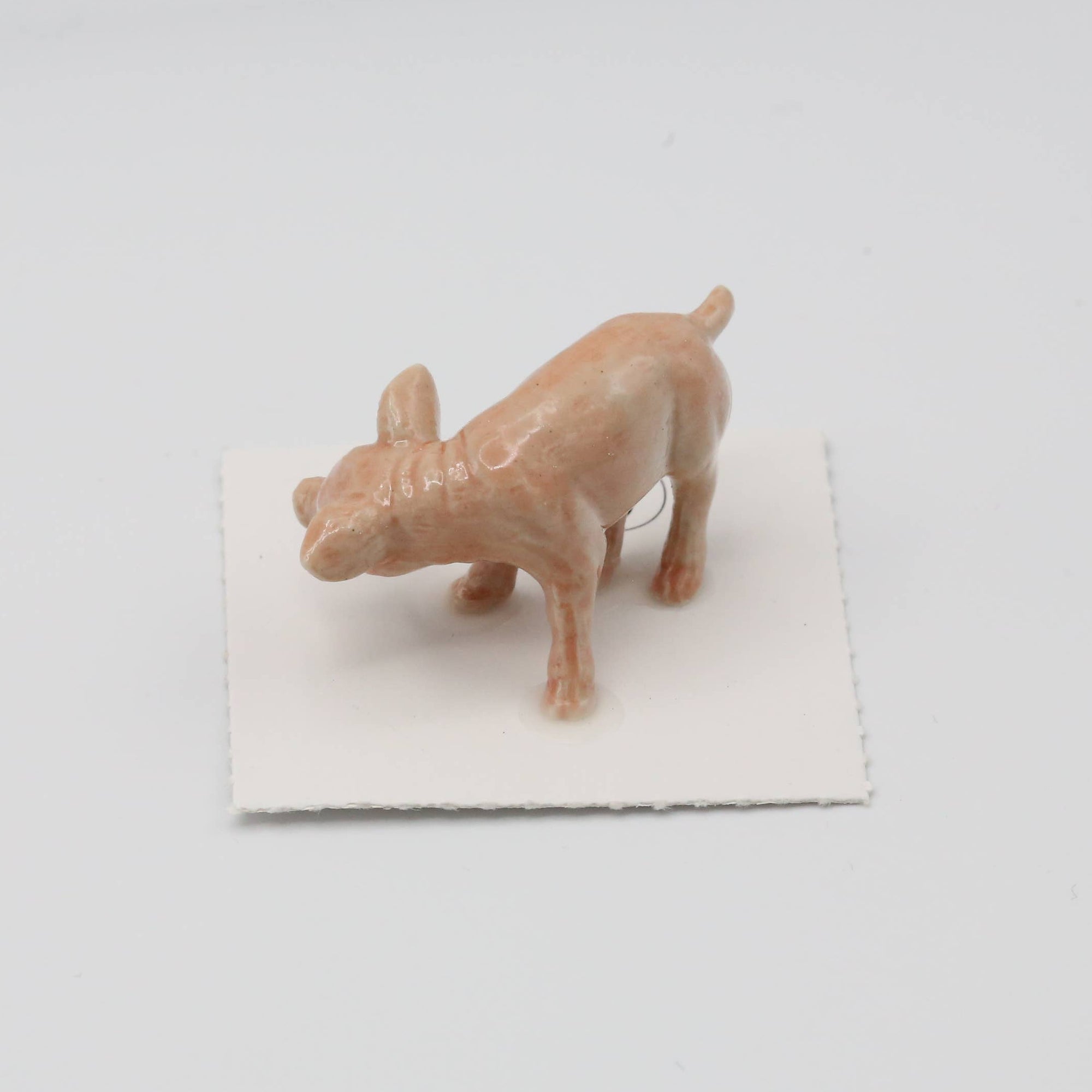 Small figurine of a dog on a white background