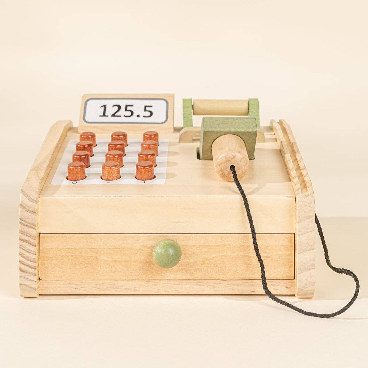 Wooden register with buttons and a digital display on a beige background