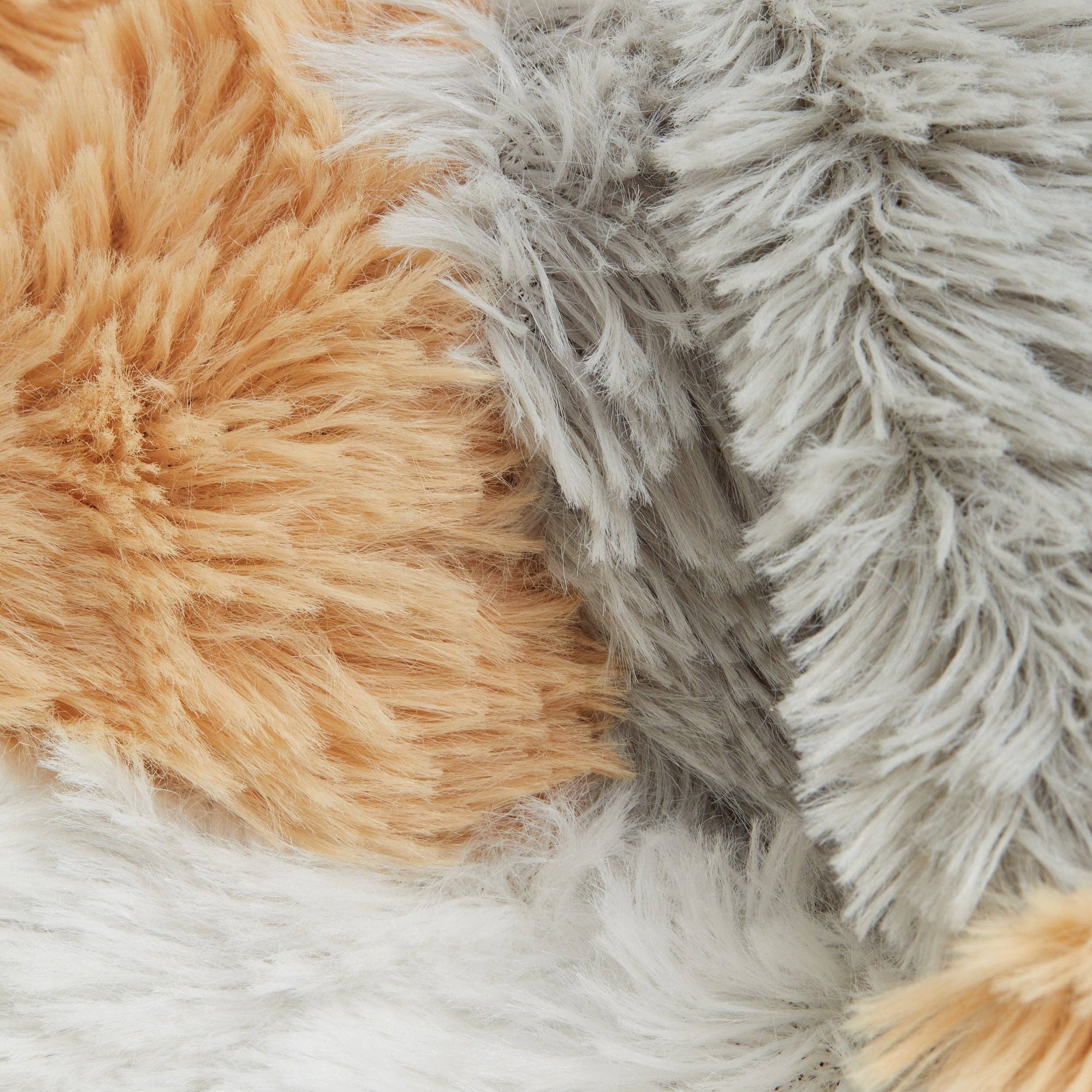Close-up of brown, gray, and white fluffy textures
