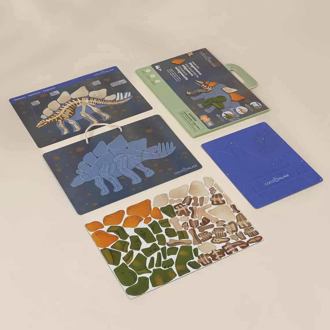 Set of dinosaur-themed cards on a beige surface