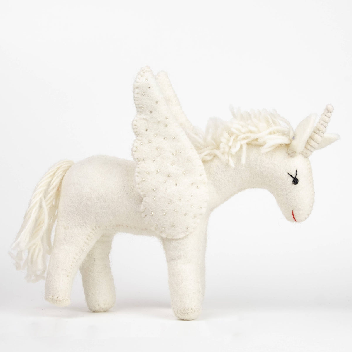 White unicorn plush toy on a white background