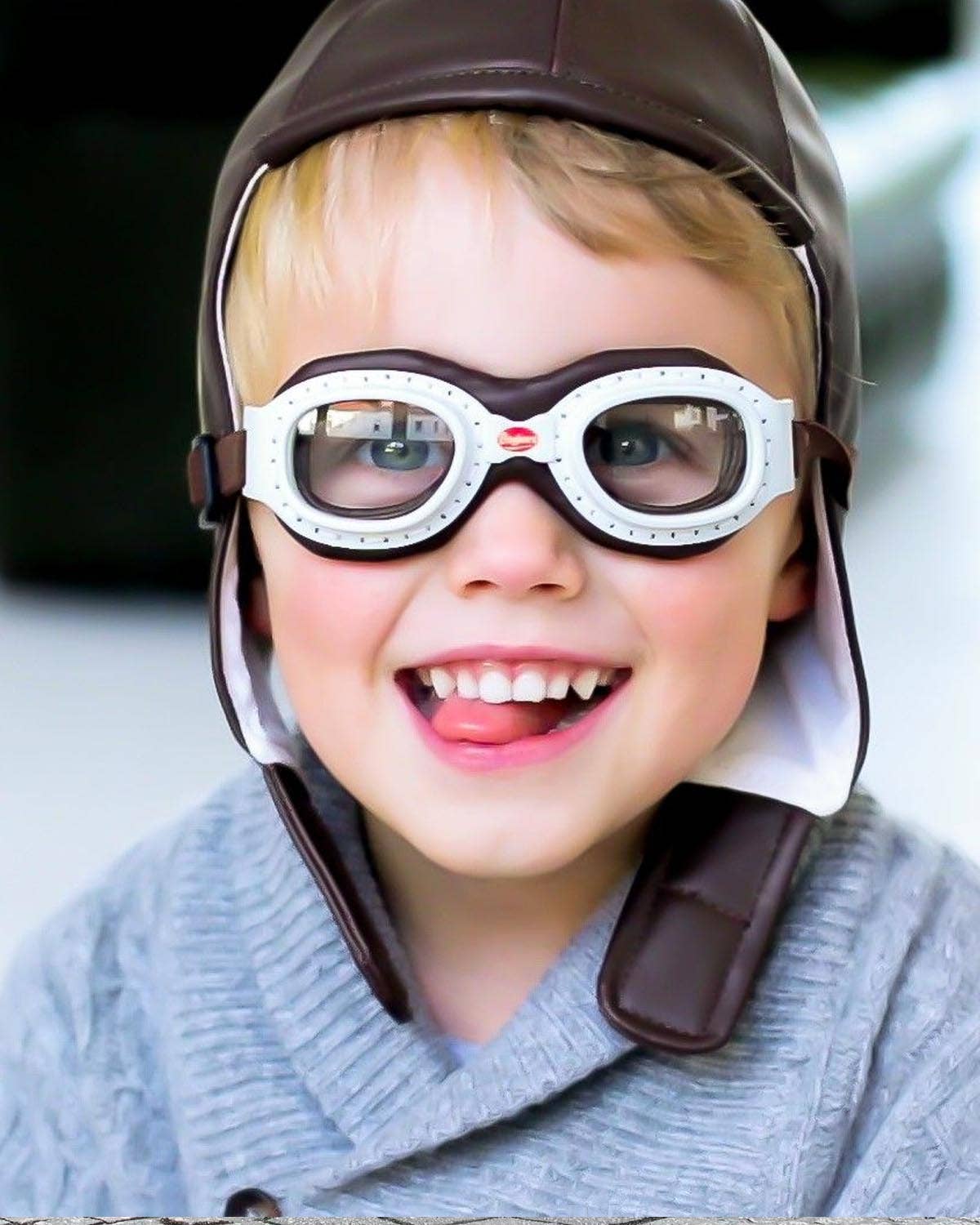 Child wearing a helmet and goggles with a blurred background
