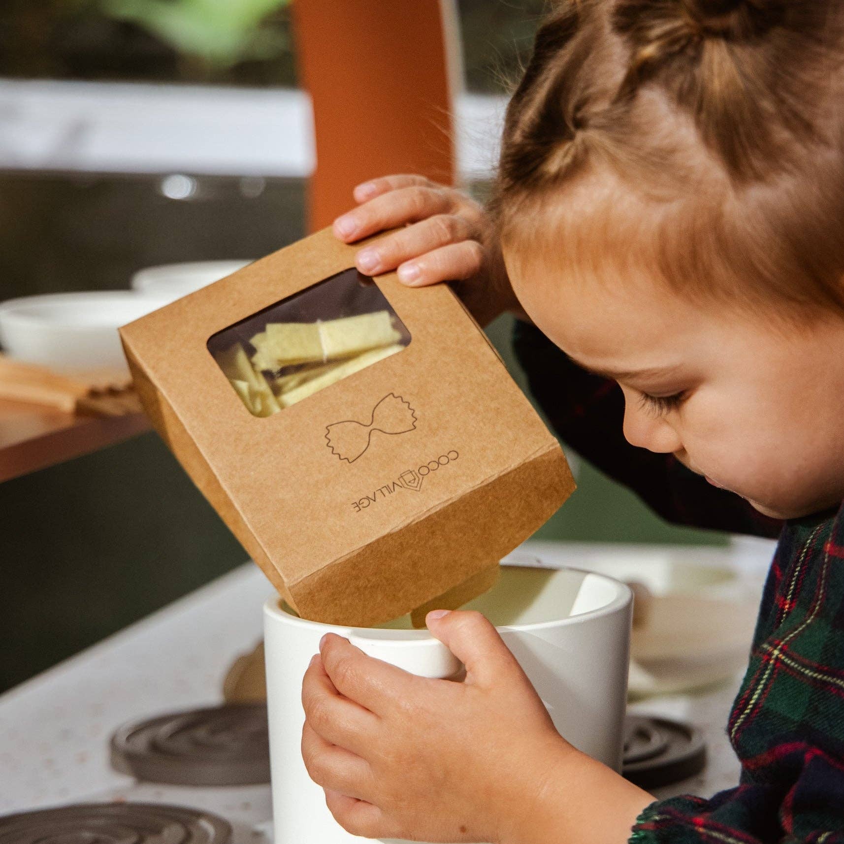 Child interacting with a kitchen appliance on a stovetop